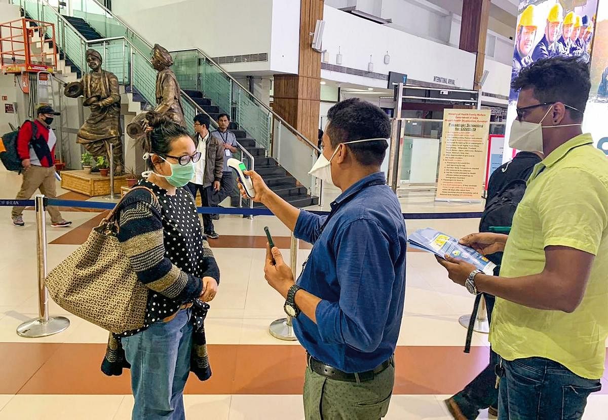 Passengers undergo a thermal screening test in the wake of novel coronavirus scare at Lokpriya Gopinath Bordoloi International Airport in Guwahati. PTI