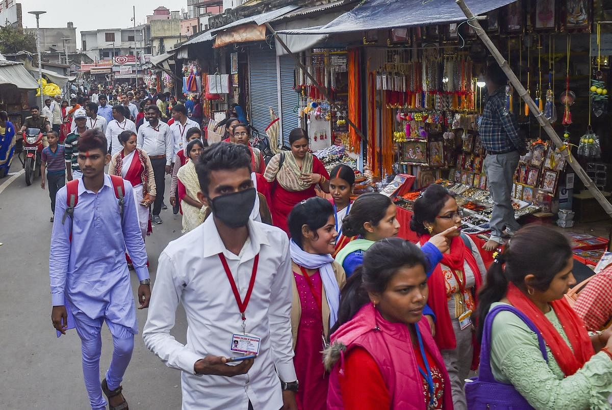 A man wearing protective mask in the wake of coronavirus pandemic walks along Ramlala market in Ayodhya, Saturday, March 14, 2020. (PTI Photo)