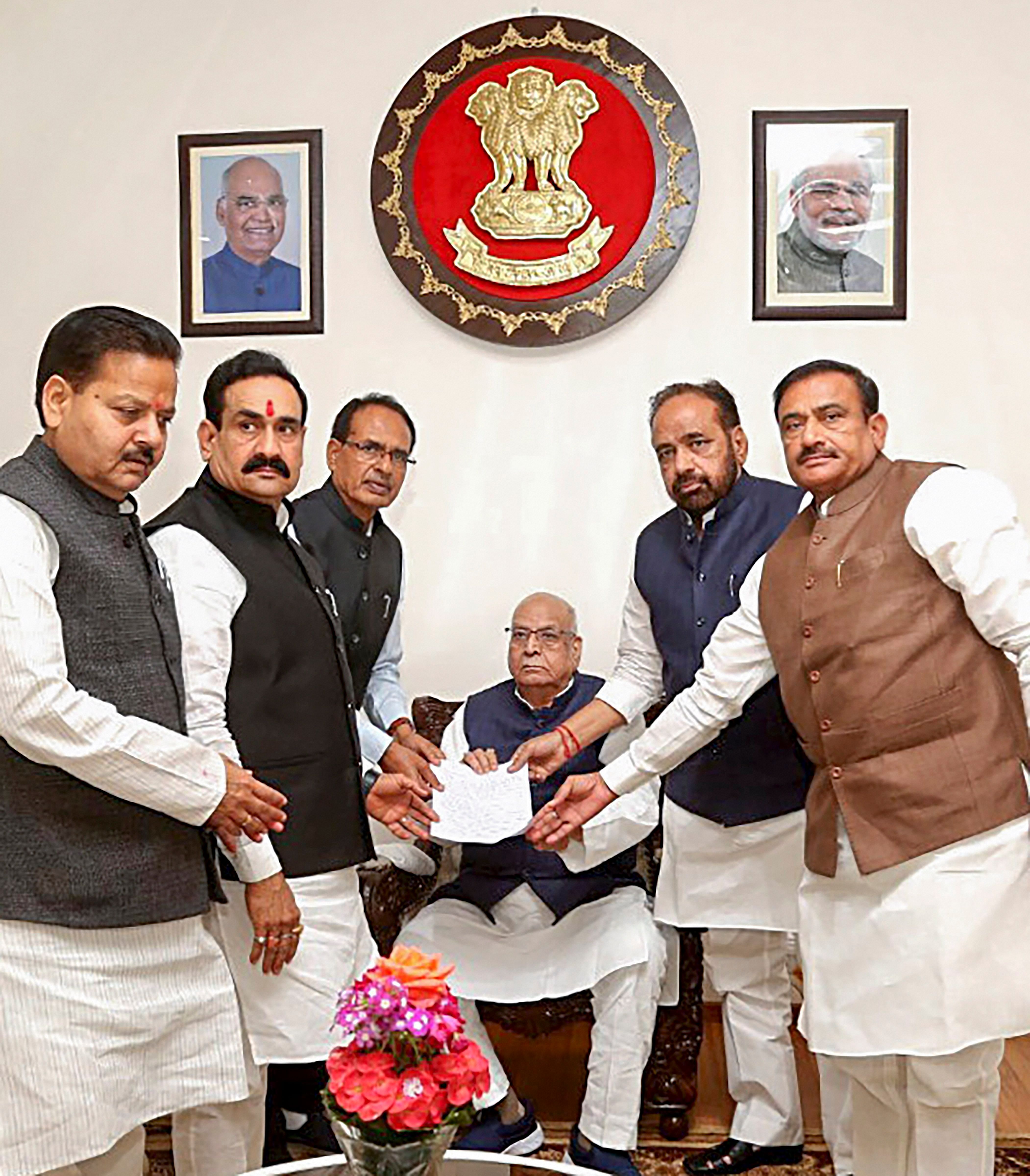 BJP National Vice President Shivraj Singh Chouhan along with leader of the opposition in the State Assembly Gopal Bhargava and party MLAs submit a memorandum demanding a floor test to MP Governor Lalji Tandon at Raj Bhavan in Bhopal.(Credit: PTI Photo)