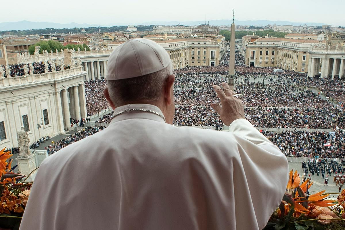 This file photo taken and handout on April 21, 2019 by the Vatican press office, Vatican Media, shows Pope Francis delivering the "Urbi et Orbi" blessing to the city and to the world from the balcony of St Peter's basilica after the Easter Sunday Mass in the Vatican. - March 15, 2020 Vatican says to hold Easter celebrations without congregation due to coronavirus. AFP/Vatican Media