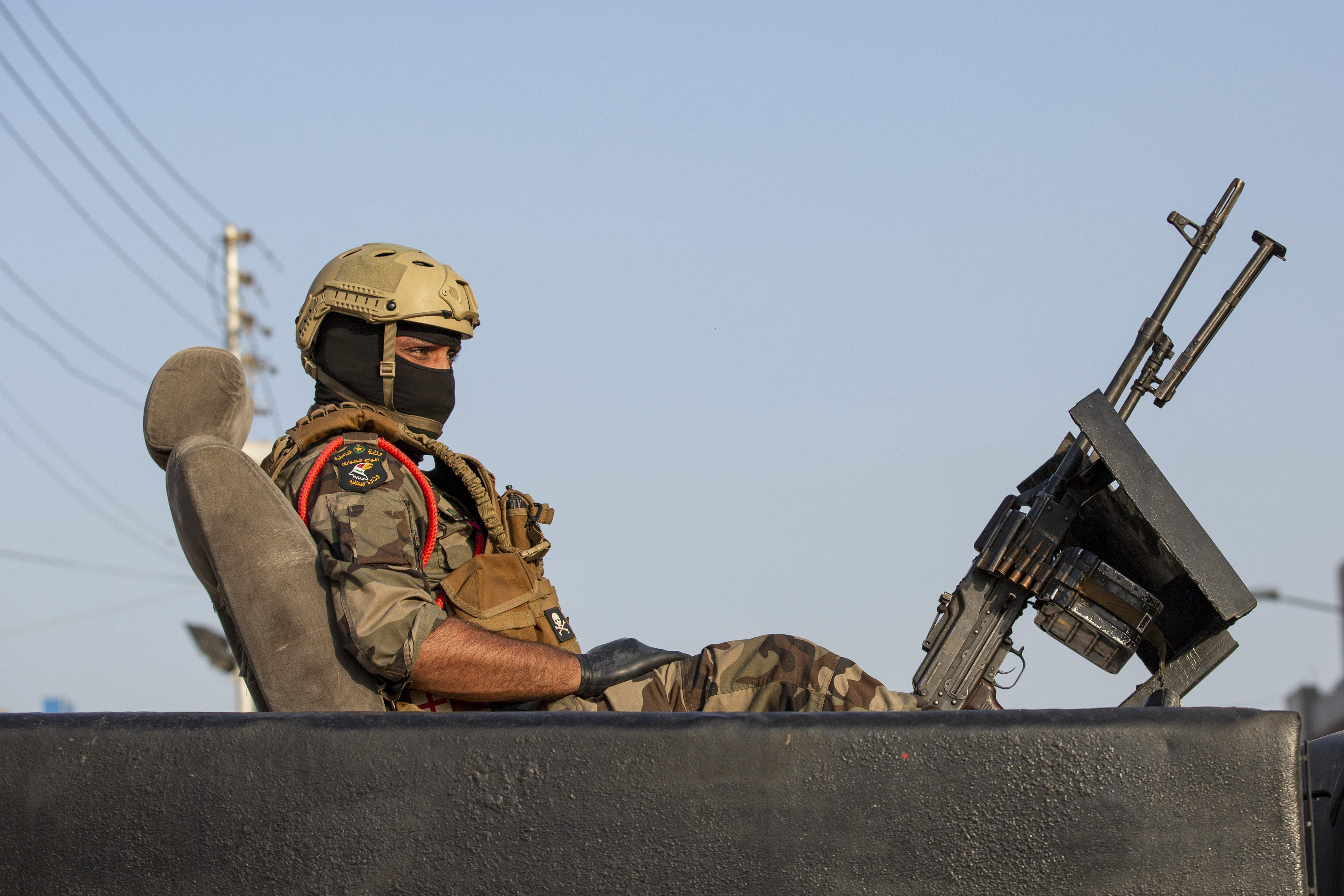 A soldier sits atop a vehicle in Iraq's southern city of Basra. (AFP Photo)