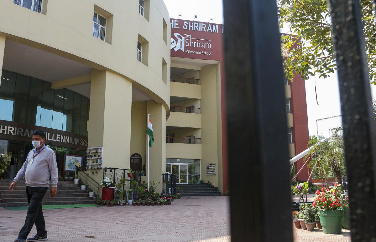 A staff member of Shriram Millennium school leaves the campus as the school closed for two days after a student's parent-tested positive with novel coronavirus or COVID-19, in Noida, Tuesday, March 3, 2020. (PTI Photo)