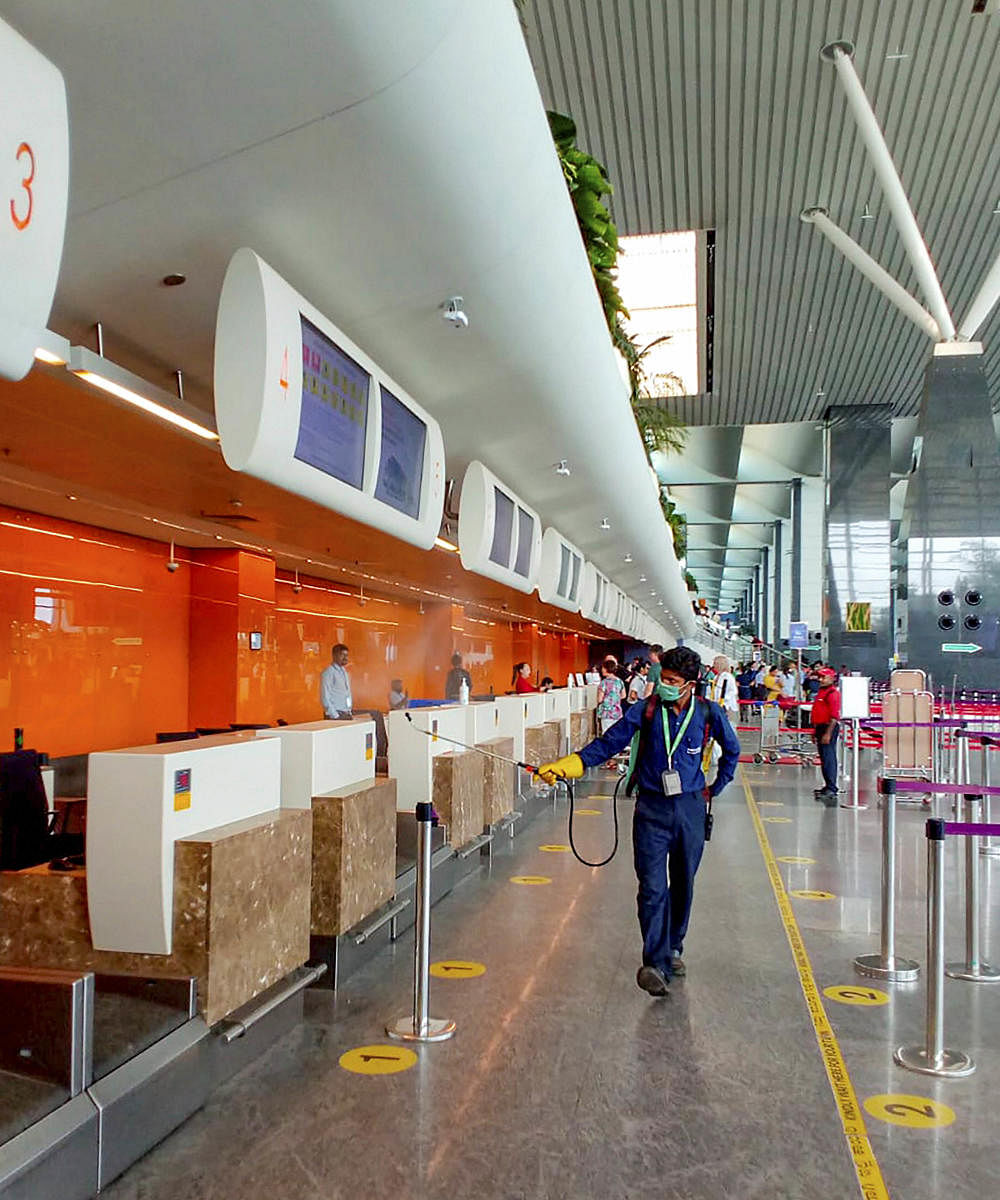 A health official disinfects Kempegowda International Airport in the wake of coronavirus (COVID-19) pandemic, in Bengaluru. (PTI Photo)