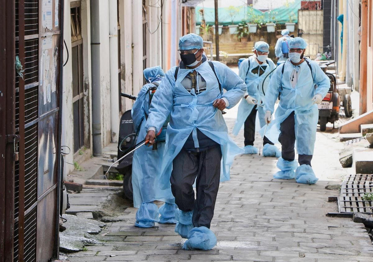 Health officials disinfect a street as part of measure to contain coronavirus pandemic, in Jammu, Saturday, March 14, 2020. (PTI Photo)