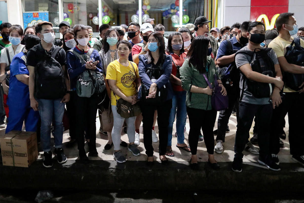 People wearing protective masks struggle to maintain social distancing as they wait for on the first work day in the country's capital since the lockdown to contain coronavirus, in Quezon City, Metro Manila. Credit: Reuters Photo