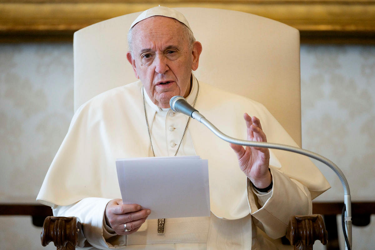 Pope Francis speaks during his general audience as it is streamed via video over the internet from a library inside the Vatican. Credit: Reuters Photo