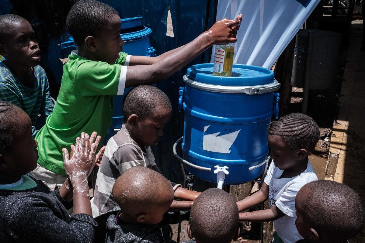 Children learn how to wash hands for prevention of the COVID-19 as local NGO Shining Hope for Communities (SHOFCO) installs hand washing stations at Kibera slum in Nairobi. Credit: AFP Photo