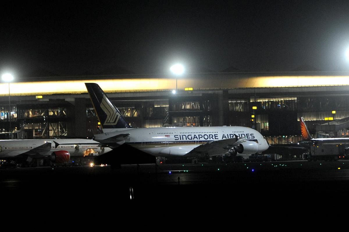 Singapore Airlines carrying Indian nationals in the wake of the coronavirus pandemic stands parked on arrival at Mumbai International Airport, Thursday night, March 19, 2020. (PTI Photo)