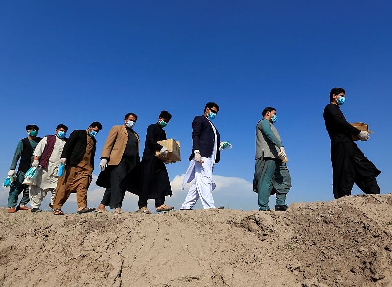 Members of civil society activists, distribute face masks to the villagers during a campaign spreading the awareness of the coronavirus disease (COVID-19), in Nangarhar province, Afghanistan. (Reuters Photo)
