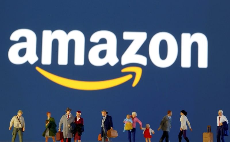  Small toy figures are seen in front of diplayed Amazon logo in this illustration. (Reuters Photo)
