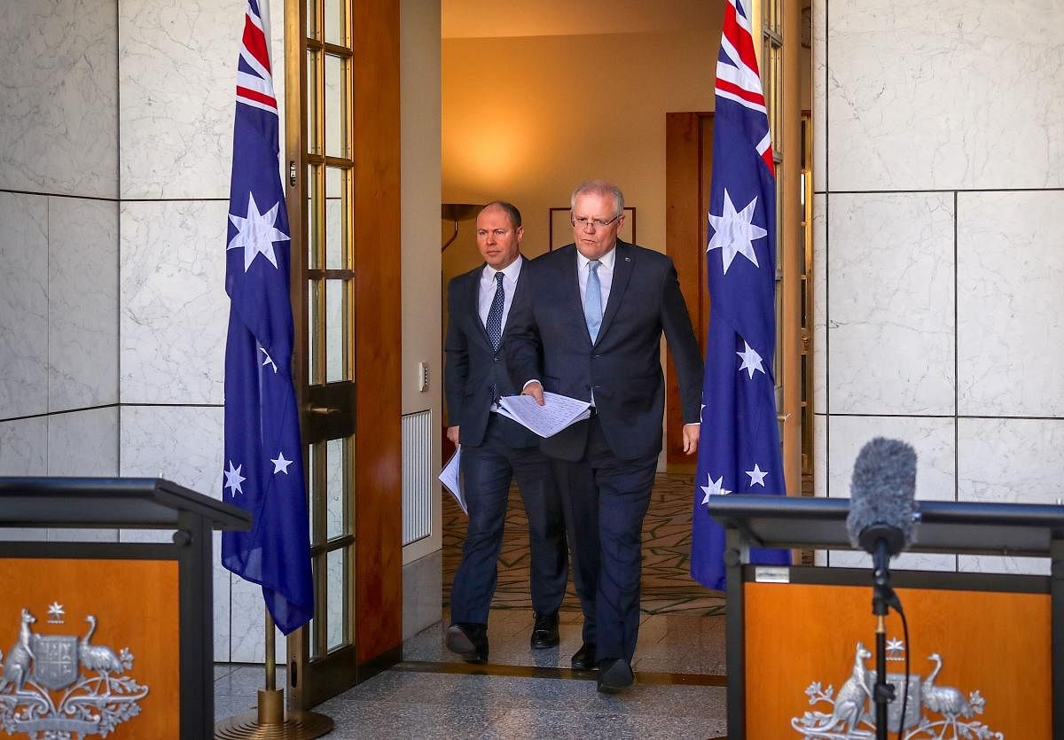 Australian Prime Minister Scott Morrison (R) and Australian Treasurer Josh Frydenberg arrives at a press conference at Australia's Parliament House in Canberra. AFP
