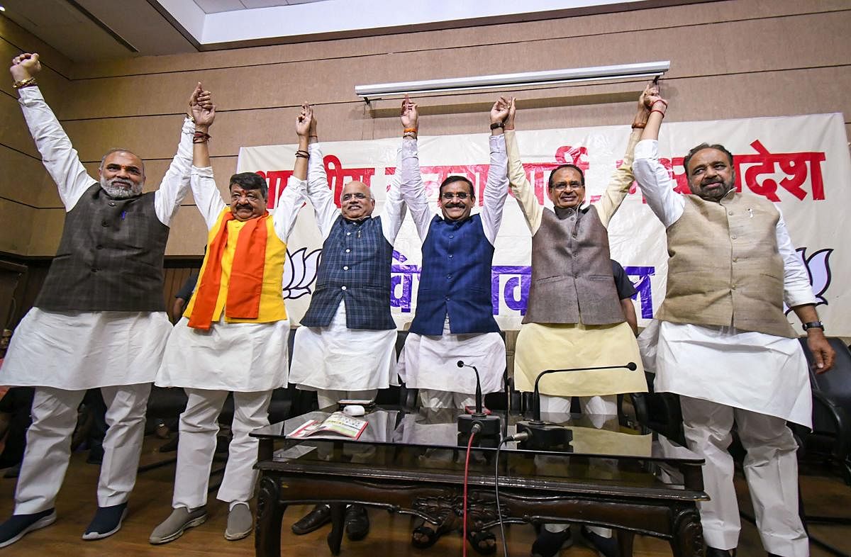 BJP leaders Shivraj Singh Chouhan (2R), VD Sharma, Gopal Bhargava, Vinay Sahasrabuddhe and Kailash Vijayvergiya and other celebrate during BJP legislative party meeting after Madhya Pradesh Chief Minister Kamal Nath resigned from his post, at state party headquarters in Bhopal, Friday, March 20, 2020. (PTI Photo)