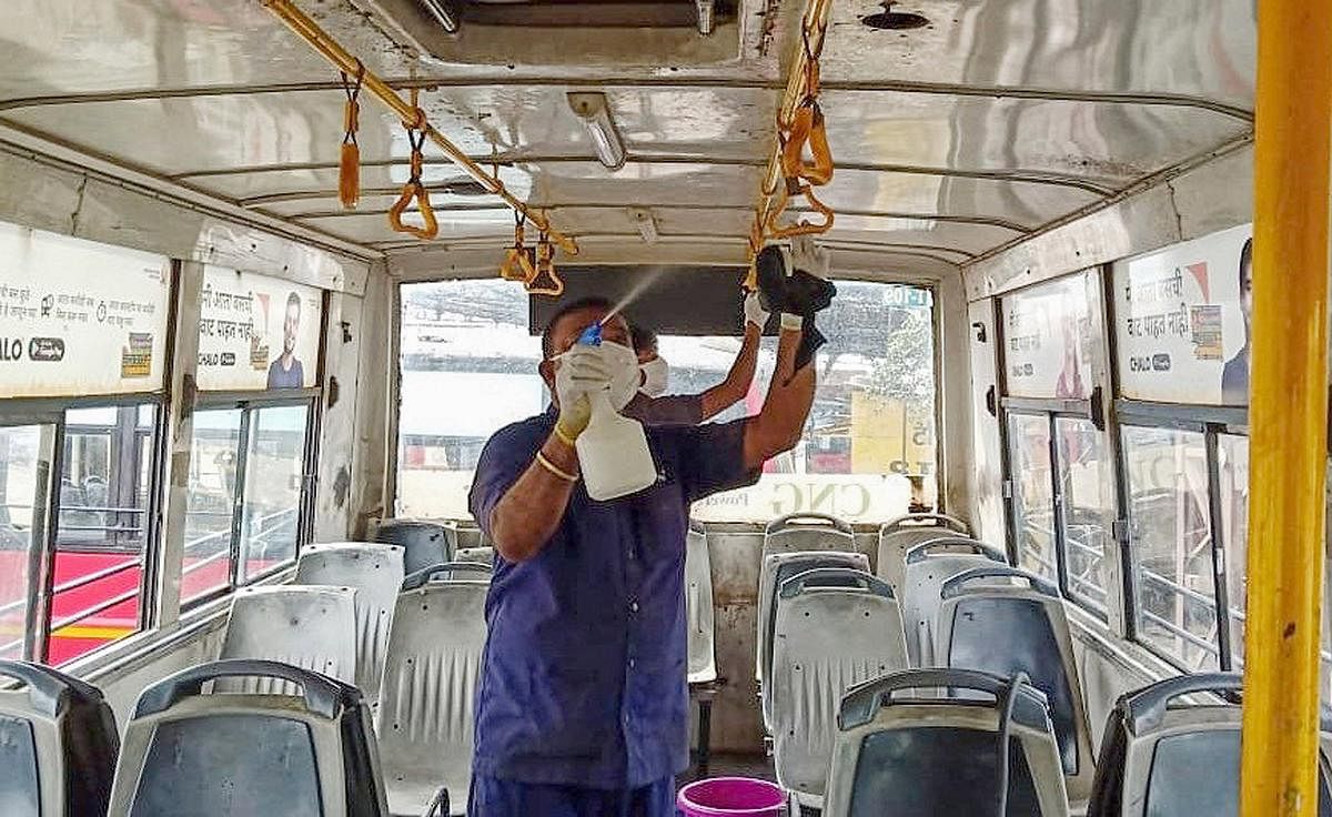 A health official sprays disinfectants inside a city bus in the wake of coronavirus pandemic, in Nagpur, Saturday, March 14, 2020. (PTI Photo)