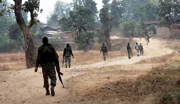 CRPF personnel patrol at Maoist affected area near village Sayu, in Latehar, Wednesday, Dec. 5, 2018. (PTI Photo)