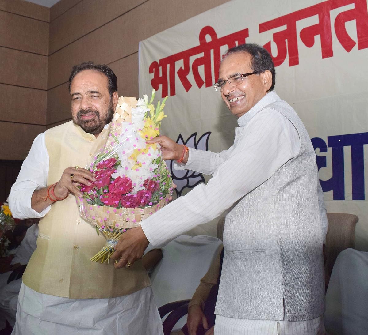 BJP National President Shivraj Singh Chouhan being greeted by party leader Gopal Bhargava during BJP legislature party meeting at BJP State headquarters in Bhopal. (PTI Photo)