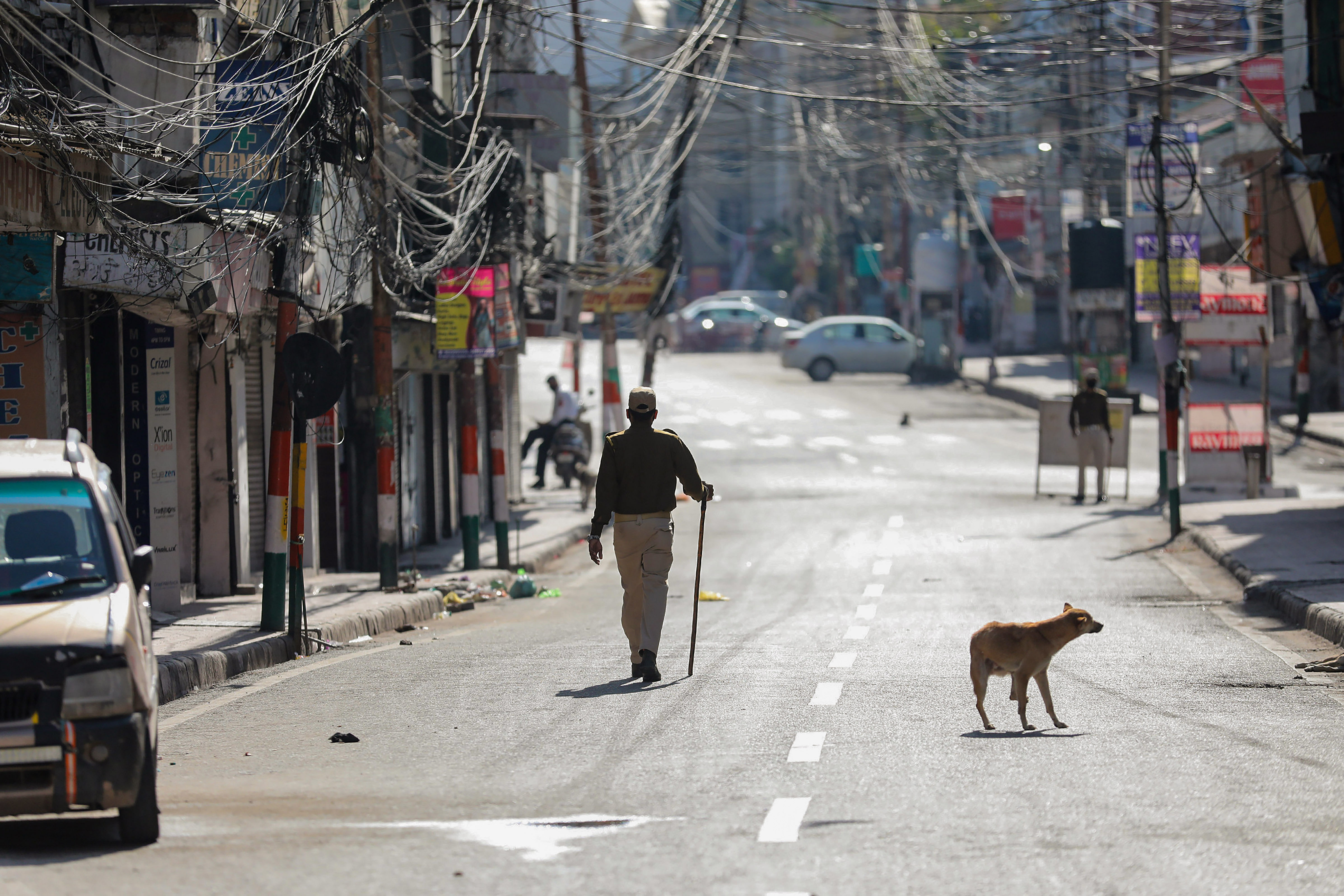 A policeman walks along a deserted road in Jammu. (PTI photo)