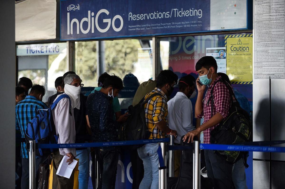 People lineup at a IndiGo Airlines ticket counter at the Sardar Vallabhbhai Patel Airport in Ahmedabad on March 23, 2020. Credit: AFP Photo