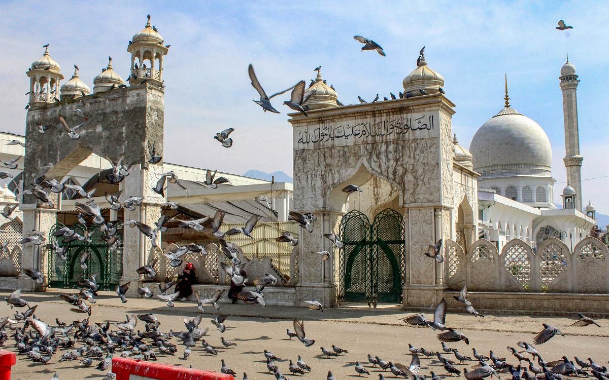  Pigeons fly outside closed famous Dargah Hazratbal Shirne on Miraj-un-Nabi (SAW) festival , which was closed for all regular prayers in wake of spreading of novel coronavirus , in Srinagar, Monday March 23, 2020. (PTI Photo)