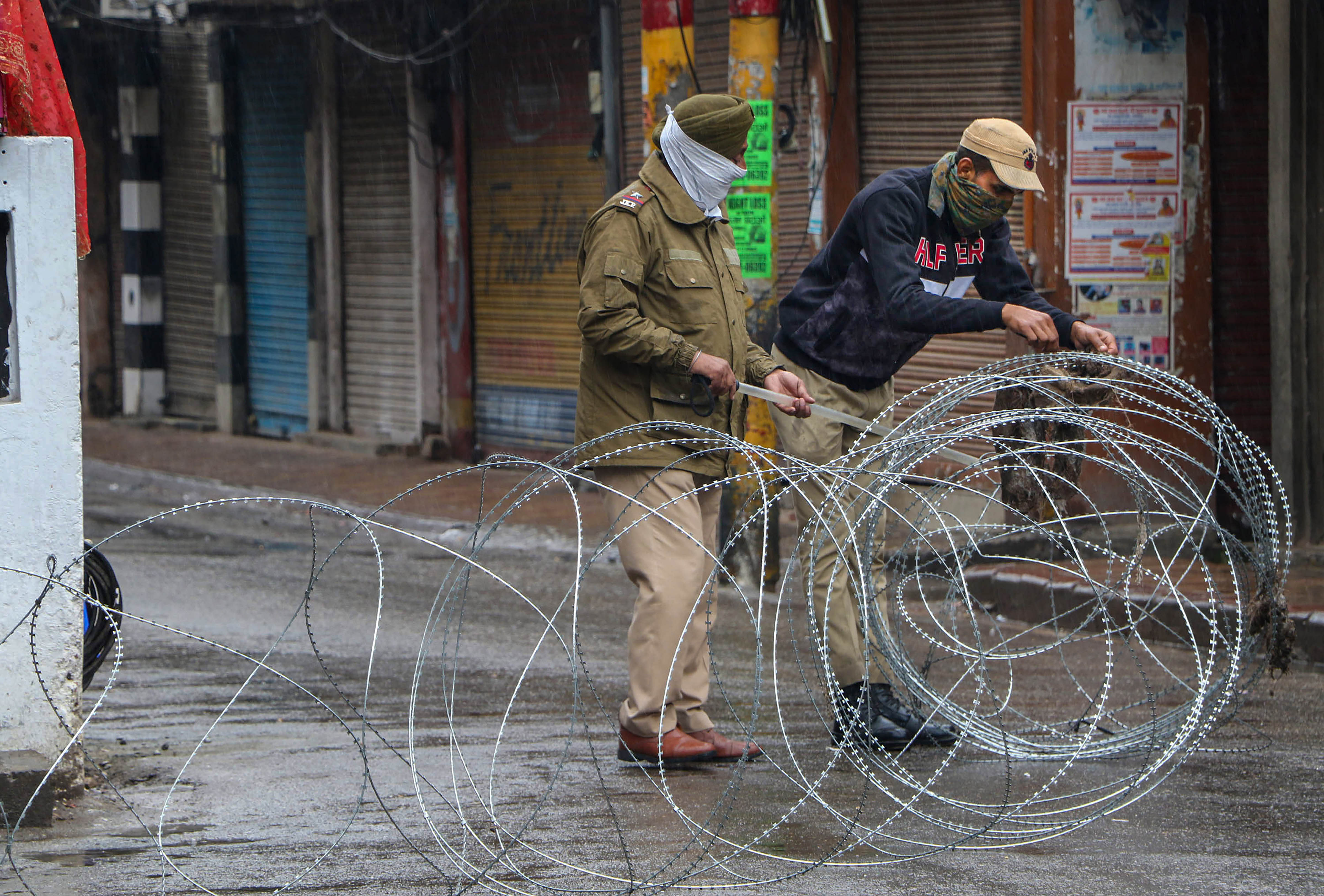 Security personnel put concertina wires to block a road during lockdown in the wake of coronavirus outbreak, in Jammu. (PTI Photo)