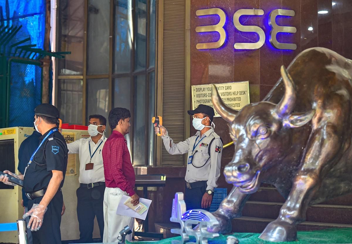 Security personnel use thermal screening devices on visitors to mitigate the coronavirus pandemic, at BSE Building in Mumbai. (PTI Photo)