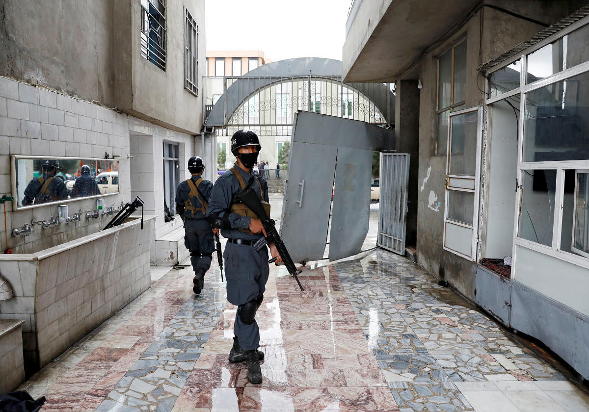 Afghan policemen inspect inside a Sikh religious complex after an attack in Kabul, Afghanistan March 25, 2020. (REUTERS Photo)