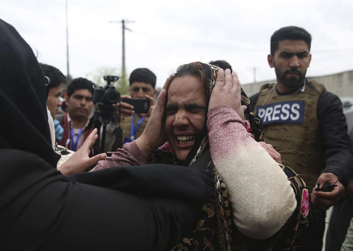 Family members cry after an attack in Kabul, Afghanistan, Wednesday, March 25, 2020. Credit: AP Photo