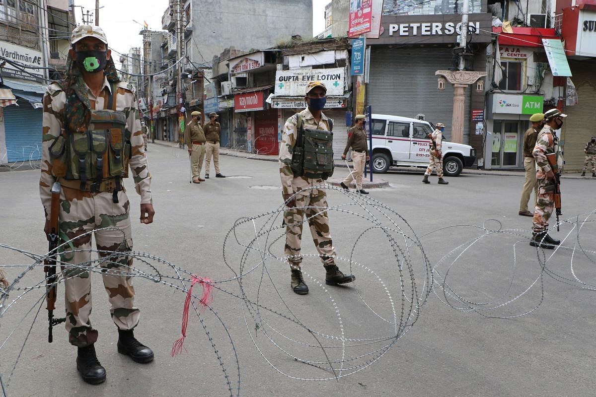  Security personnel stand guard in a street during the complete lockdown, imposed in the wake of coronavirus pandemic, in Jammu (PTI Photo)
