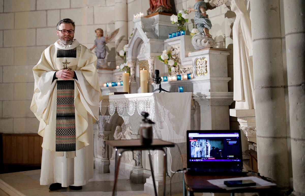 French priest Guillaume Le Floc'h conducts a mass streamed online on the feast of the Annunciation at the church in Carquefou near Nantes as a lockdown is imposed to slow the rate of the coronavirus disease (COVID-19) spread in France (Reuters Photo)