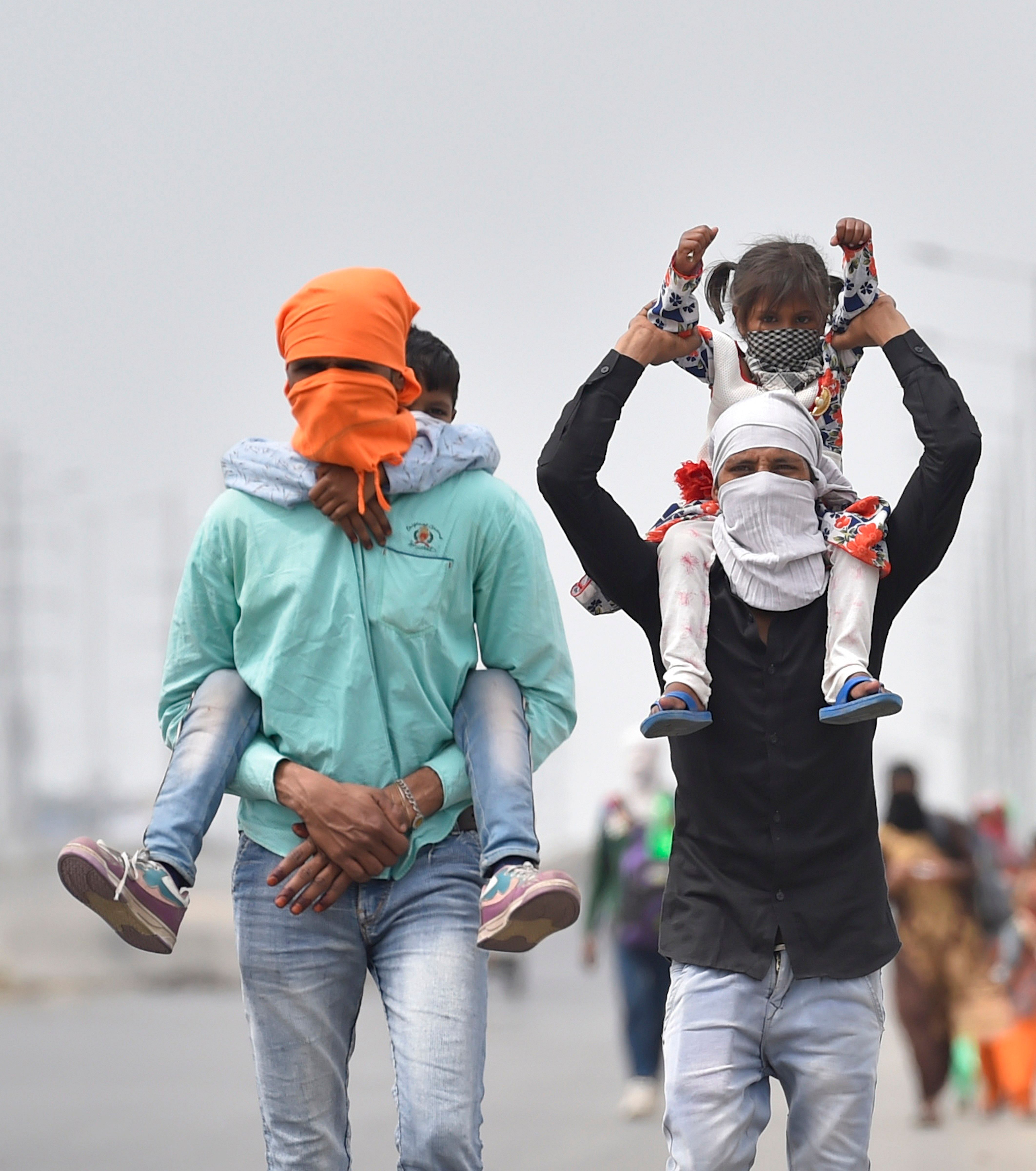 A group of migrant workers walk to their villages amid the nationwide complete lockdown, on the NH24. (Credit: PTI)