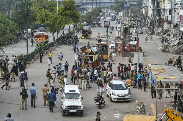 Police load in a truck the items seized from the anti-CAA protest site, at Jamia nagar in New Delhi, Tuesday, March 24, 2020. (Credit: PTI Photo)