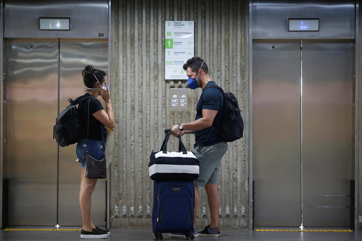 Travelers wearing protective face masks are seen at Brazilian International Airport amid the coronavirus disease (COVID-19) outbreak in Brasilia (Reuters Photo)