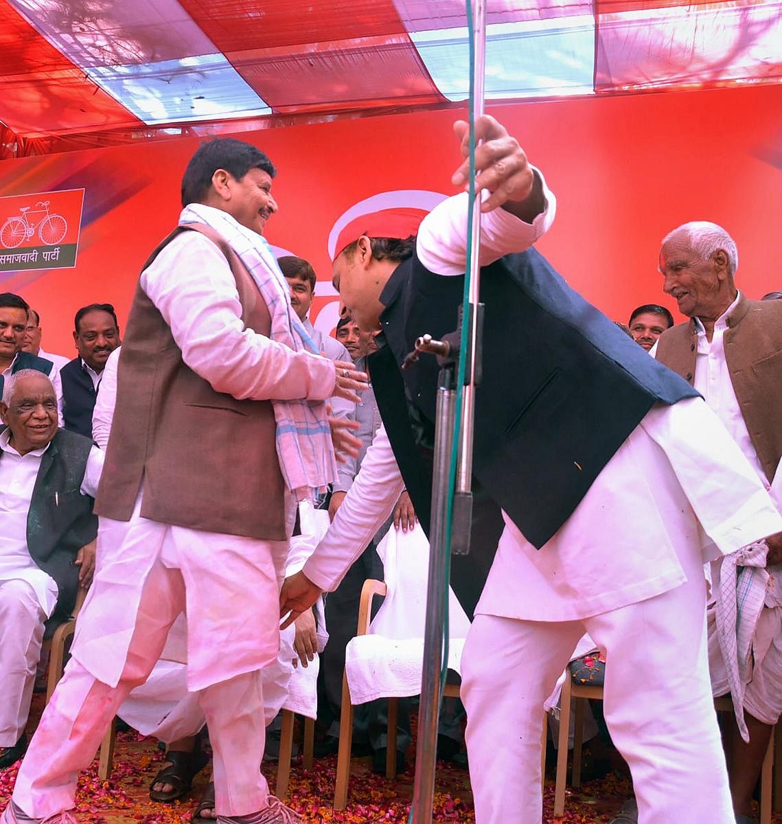 SP leader Akhilesh Yadav seeks blessings from Pragatisheel Samajwadi Party leader Shivpal Singh Yadav during an event to celebrate Holi festival, in Etawah, on March 10, 2020. PTI