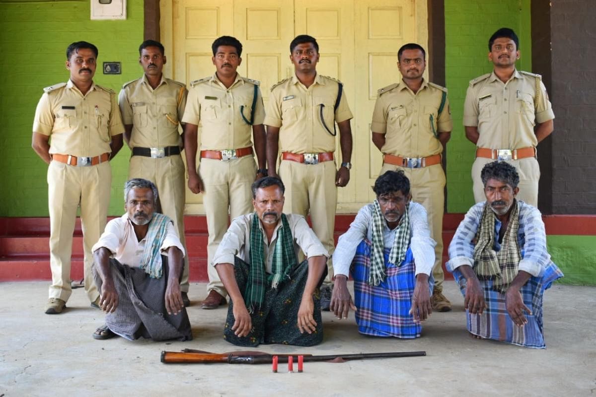 Poachers with Forest department officials, at Bandipur National Park, on Saturday.