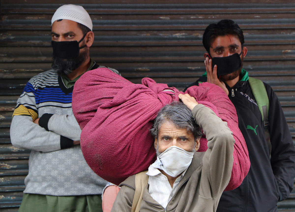 Stranded passengers near a bus stand during day-3 of the nationwide lockdown, imposed in the wake of coronavirus pandemic, in Jammu, Friday, March 27, 2020. (PTI Photo)