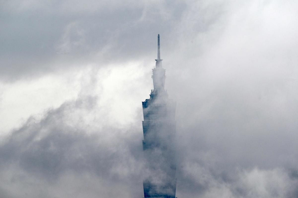 A general view shows Taipei 101, a 508-metre high commercial building, amid low-lying clouds in Taipei on March 28, 2020. (Photo by Sam Yeh / AFP)