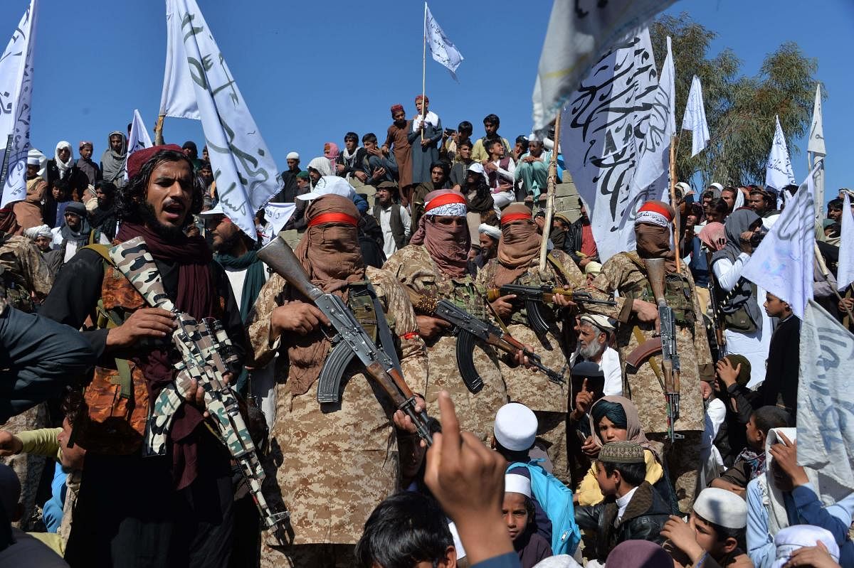 Afghan Taliban militants and villagers attend a gathering as they celebrate the peace deal and their victory in the Afghan conflict on US in Afghanistan, in Alingar district of Laghman Province on March 2, 2020. Credit: AFP Photo