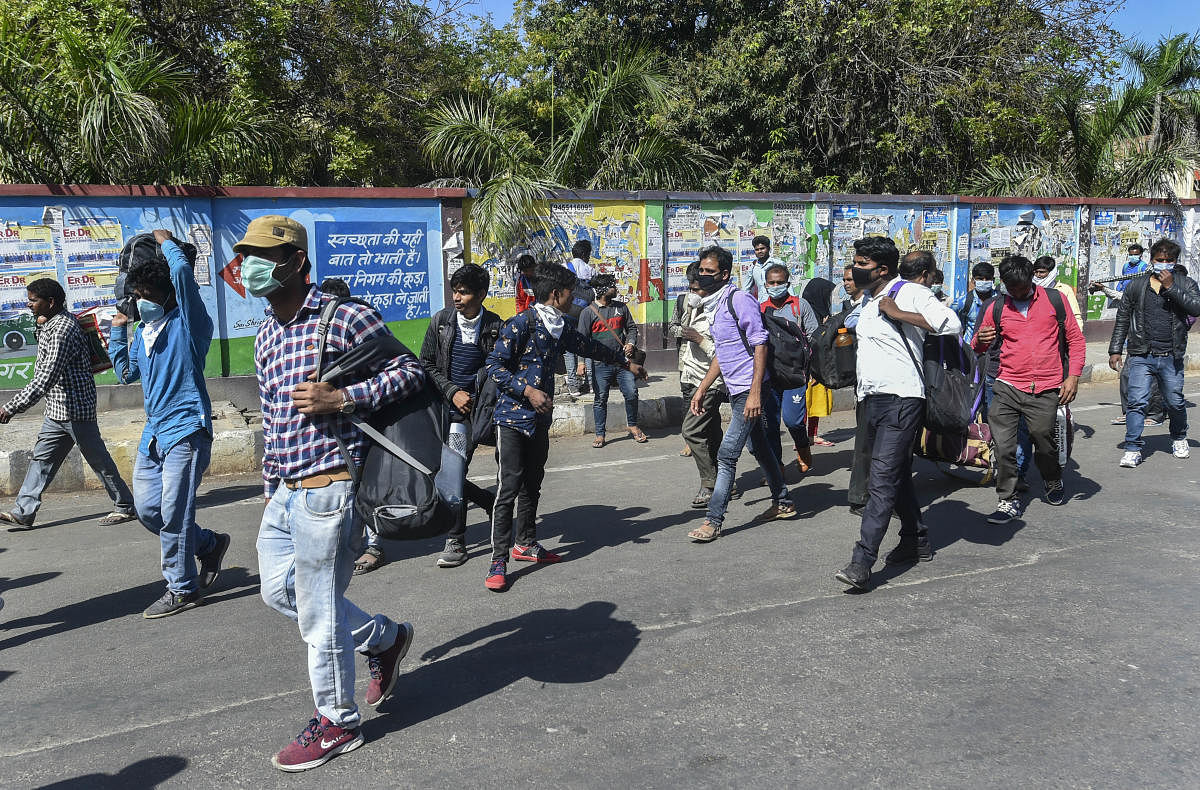 Migrants on their way back to the native places at Polytechnic Crossing during a nationwide lockdown in the wake of coronavirus pandemic, in Lucknow. PTI