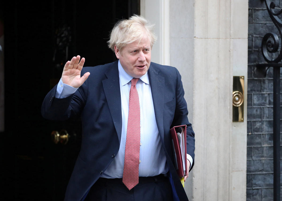 Britain's Prime Minister Boris Johnson waves as he leaves Downing Street, as the spread of coronavirus disease (COVID-19) continues. London, Britain. Credit: Reuters File Photo
