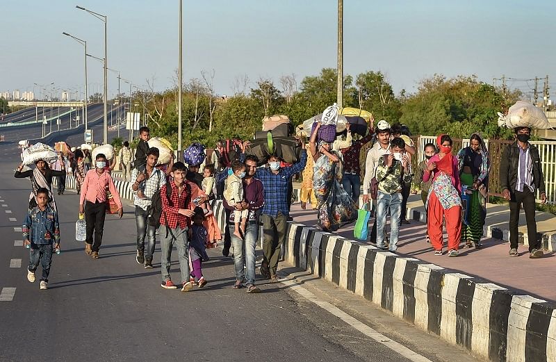 Migrant workers along with their family members walk to their native village during a nationwide lockdown, imposed in the wake of coronavirus pandemic. (PTI Photo)