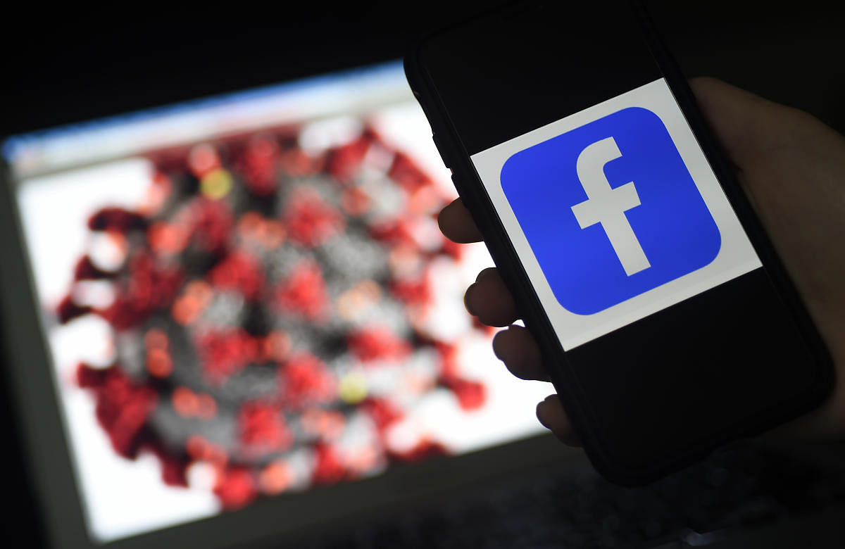In this file photo the Facebook logo is displayed on a mobile phone screen photographed on coronavirus COVID-19 illustration graphic background on March 25, 2020 in Arlington, Virginia. Credit: AFP 