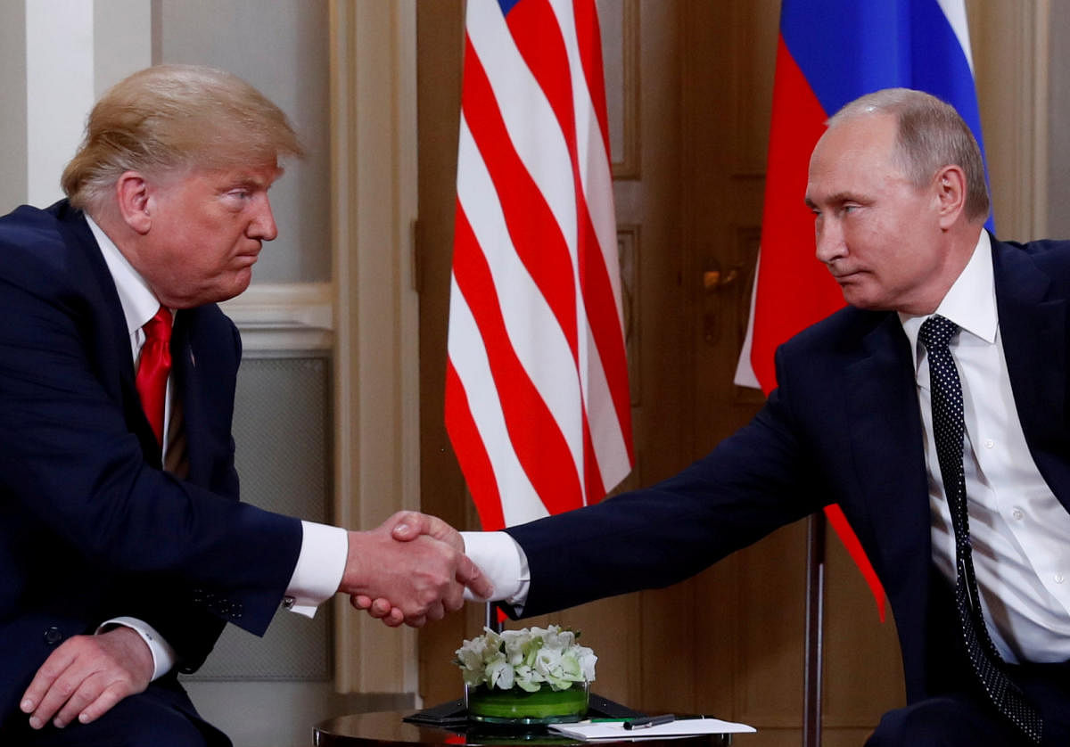 U.S. President Donald Trump and Russia's President Vladimir Putin shake hands as they meet in Helsinki, Finland July 16, 2018.  Credit: Reuters Photo