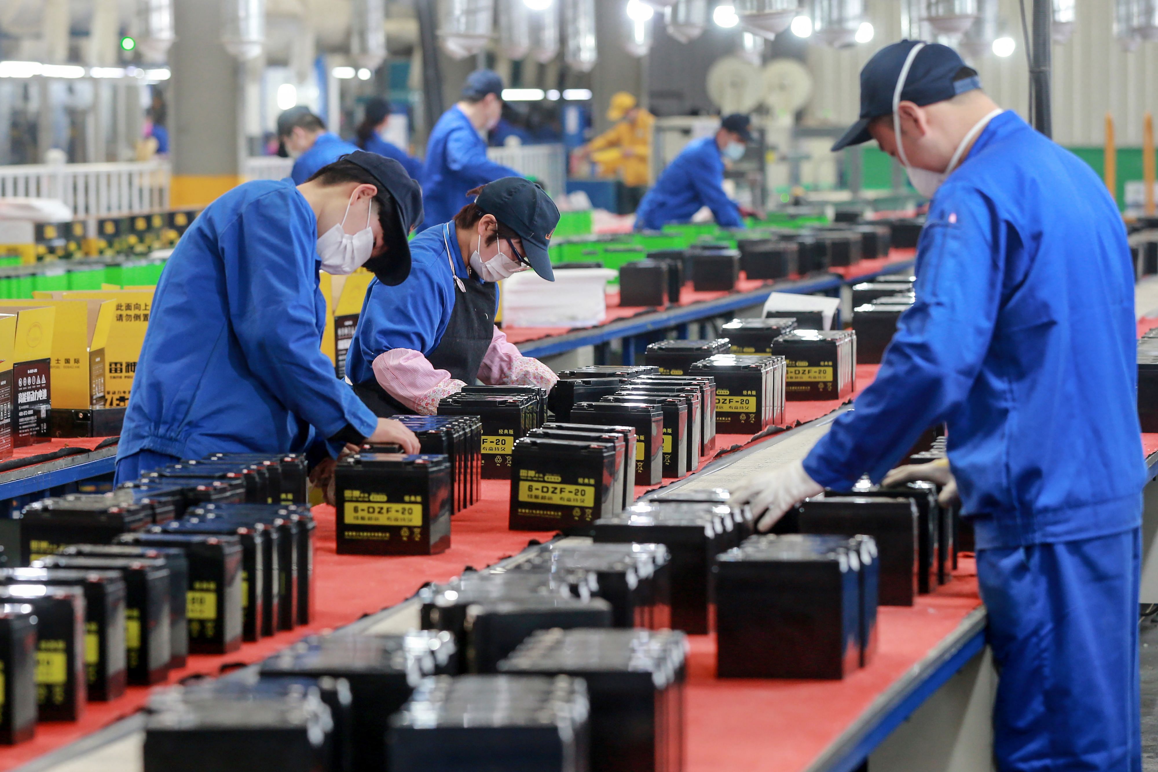 This photo taken on March 30, 2020 shows employees working on a battery production line at a factory in Huaibei in China's eastern Anhui province. (Credit: AFP Photo)
