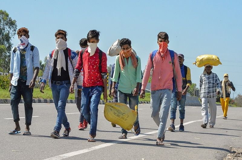 Migrants walk to try and reach their native villages during a nationwide lockdown in the wake of coronavirus pandemic, at on Ambala Yamuna Nagar Highway. (PTI Photo)