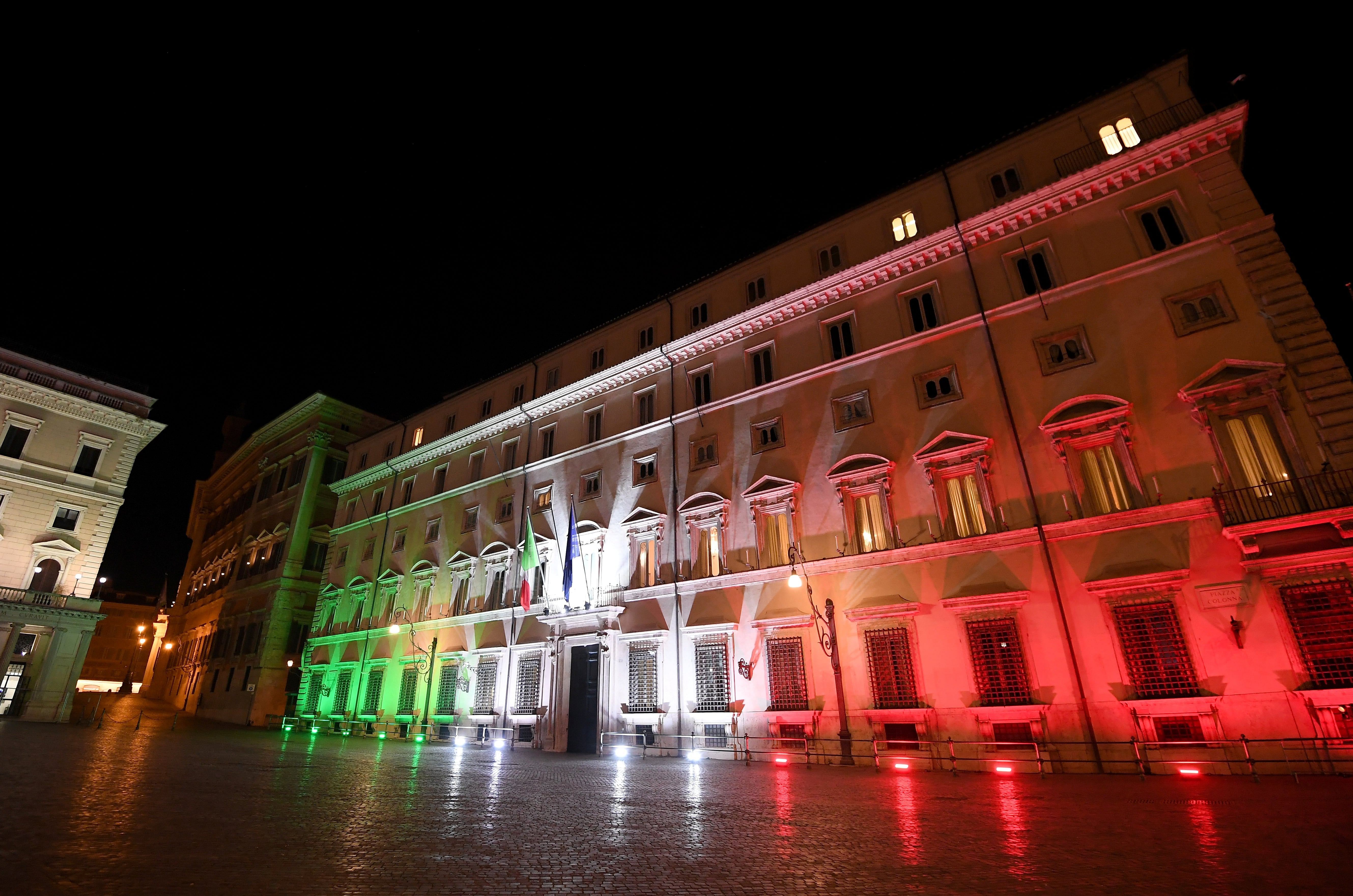 The Italian Prime Minister’s office Palazzo Chigi is lit up with the colours of the Italian flag to show solidarity with the country as it continues to battle coronavirus, in Rome. (Credit: Reuters Photo)