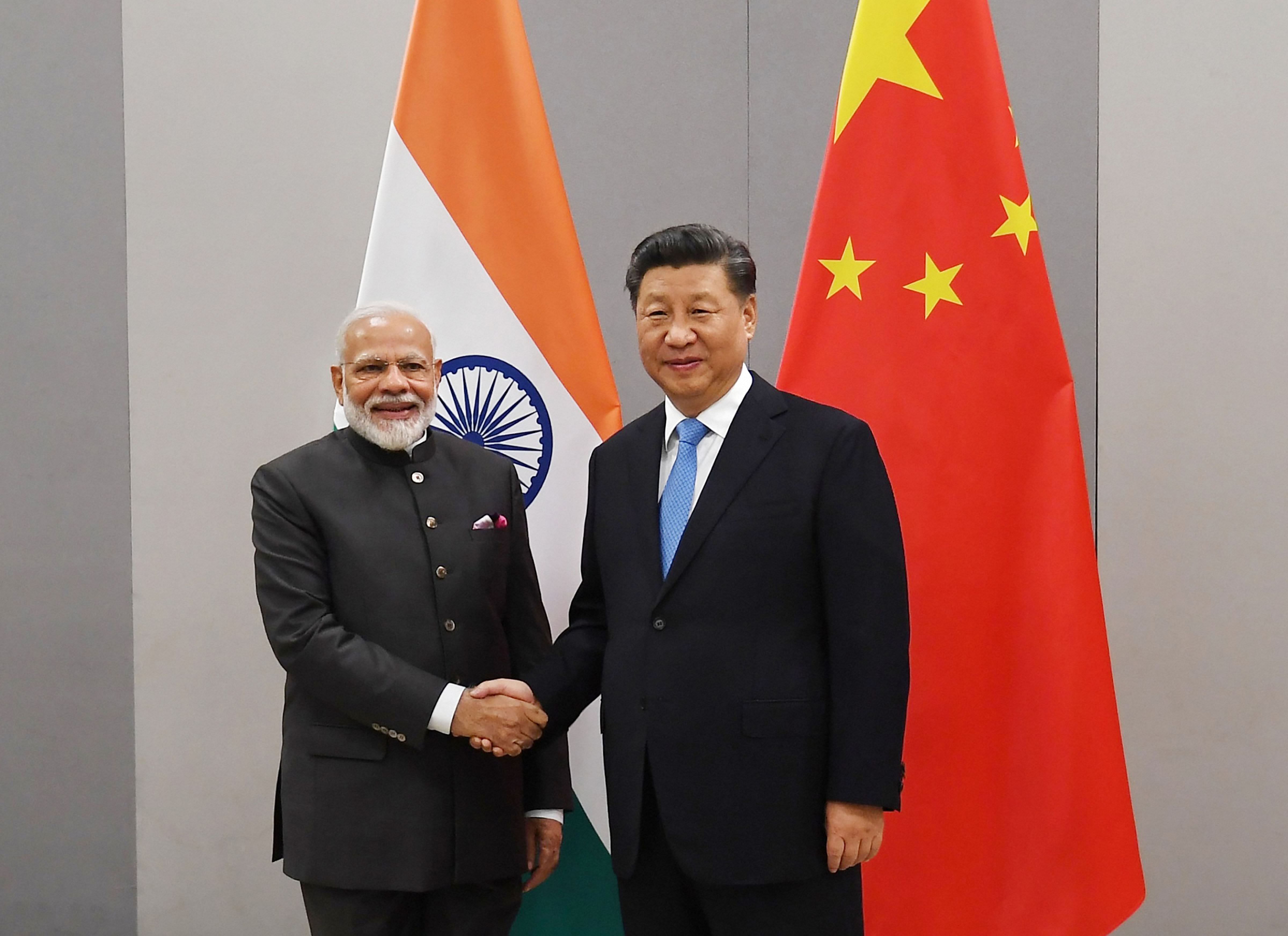 Prime Minister Narendra Modi shakes hands with Chinese President Xi Jinping. (PTI Photo)