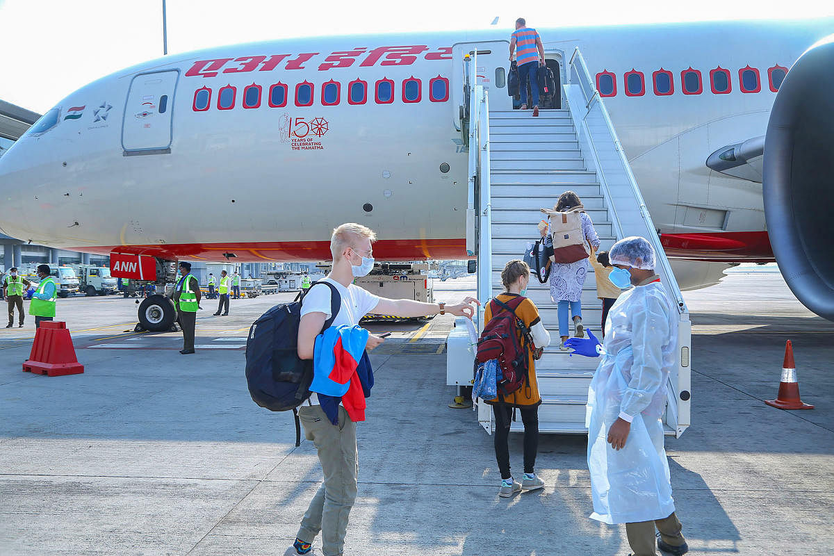 German nationals, who were stranded at various places due to the coronavirus lockdown, board a special relief flight for Mumbai, at Rajiv Gandhi International Airport in Hyderabad, Tuesday, March 31, 2020. Germans, comprising 19 females, 17 males and two infants left for Mumbai for their onward journey to Frankfurt in Germany. (Handout/PTI Photo)