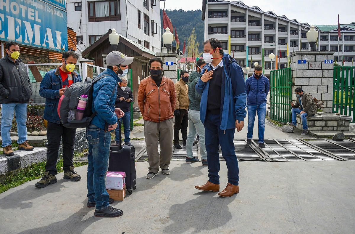  People wearing face masks walk out after completing 14-days of quarantine at a designated facility, during the nationwide lockdown to contain the spread of COVID-19, in Srinagar (PTI Photo)