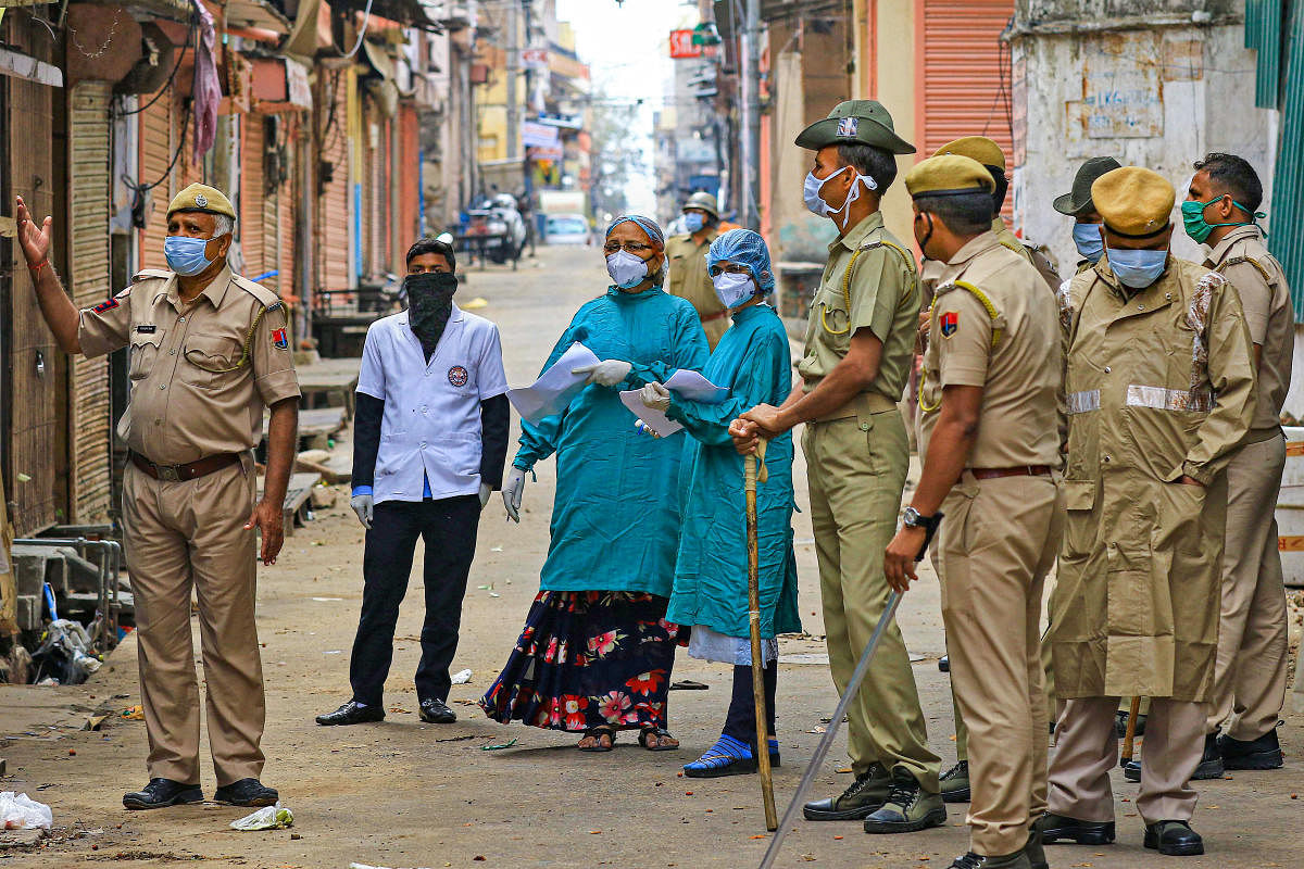  Medical team members during their door-to-door visit to screen people in wake of coronavirus pandemic, during the nationwide lockdown, at Ramganj Bazar in Jaipur, Friday, March 27, 2020. (PTI Photo)