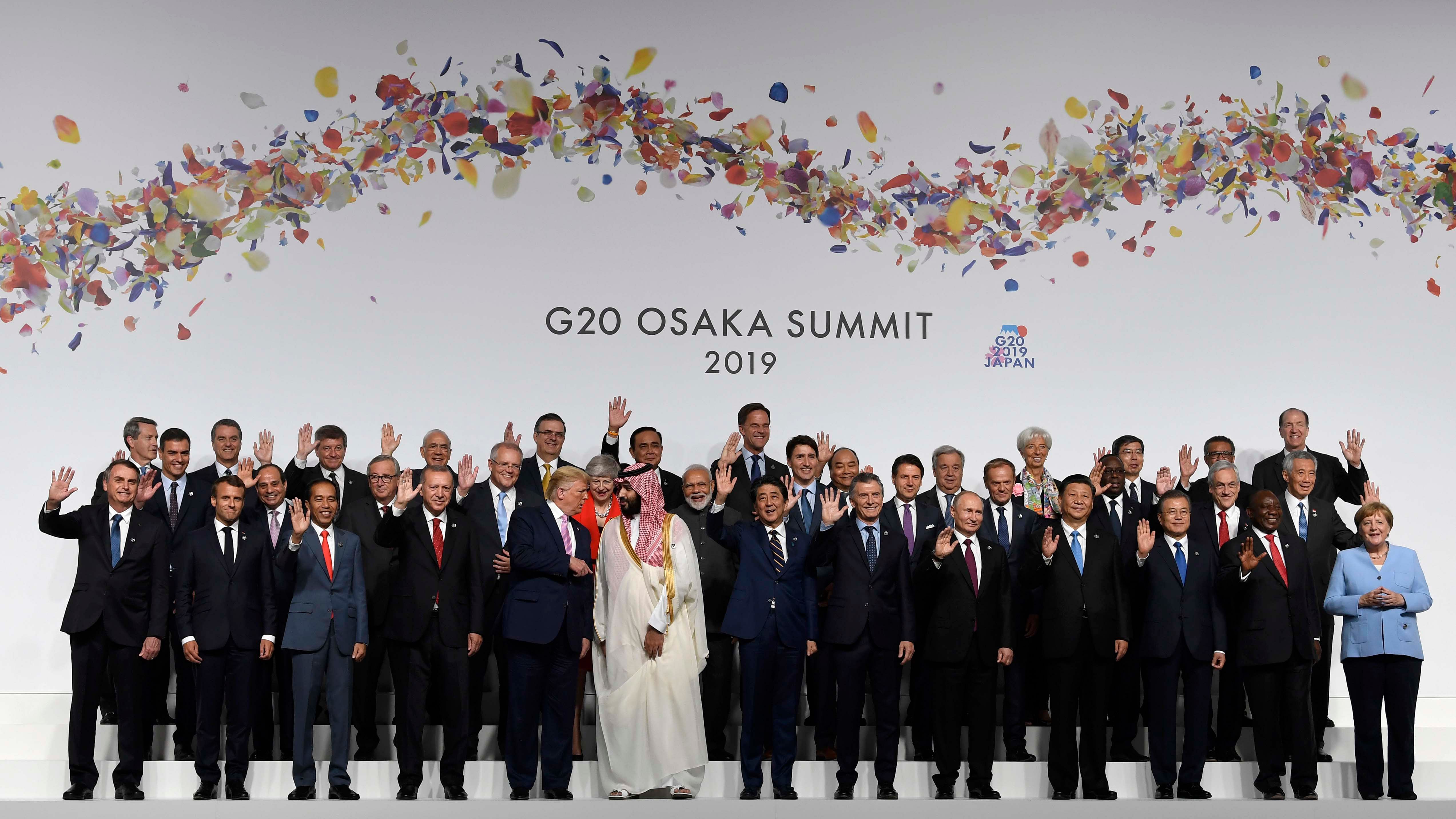 U.S. President Donald Trump talks with Saudi Arabia's Crown Prince Mohammed bin Salman during a group photo at the G-20 summit in Osaka, Japan