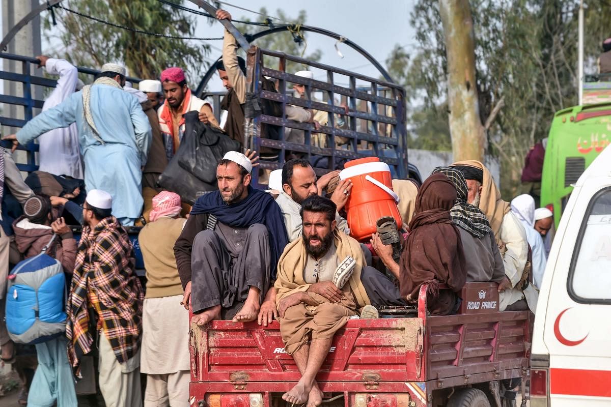 Islamic worshippers board vehicles before their departure from the three-day annual Tablighi Ijtema religious gathering in Raiwind on the outskirts of Lahore on March 13, 2020. Credit: AFP Photo